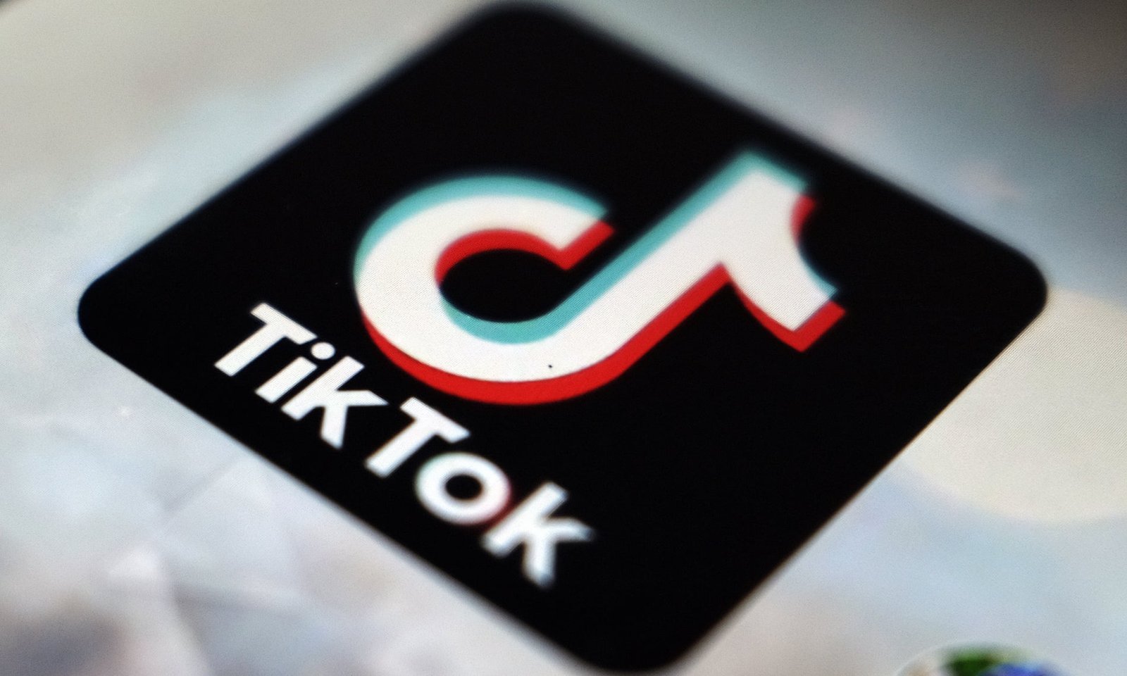 Close-up of the tiktok app icon on a digital screen, with a slight blur suggesting a lifestyle in motion or activity.